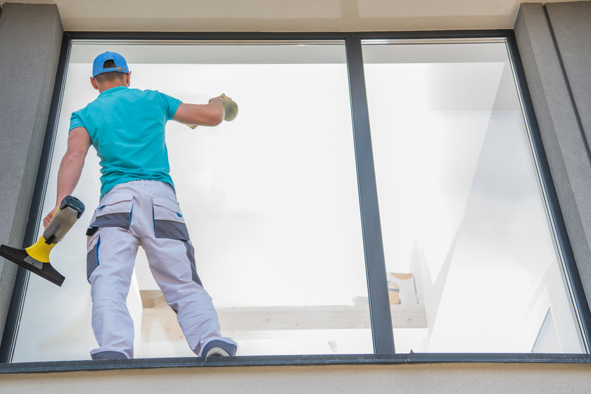 Man Cleaning Window outside